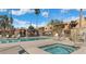 Community pool and spa with lounge chairs and shaded seating area at 3511 E Baseline Rd # 1210, Phoenix, AZ 85042