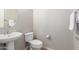 Clean and simple bathroom with pedestal sink and toilet at 3703 W Mccauley Ct, Phoenix, AZ 85086