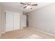 Spacious bedroom featuring a ceiling fan and ample closet space at 3703 W Mccauley Ct, Phoenix, AZ 85086