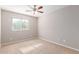 Well-lit bedroom with a window and carpet flooring at 3703 W Mccauley Ct, Phoenix, AZ 85086