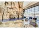 Indoor climbing wall provides challenging rock-climbing activities with natural light from large windows and comfortable seating area at 3703 W Mccauley Ct, Phoenix, AZ 85086