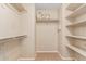 Large walk-in closet with shelving and hanging rods at 3703 W Mccauley Ct, Phoenix, AZ 85086