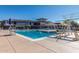 Large community pool with a diving board and slide, surrounded by lounge chairs and a recreation center at 3703 W Mccauley Ct, Phoenix, AZ 85086