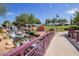 Scenic community area with a waterfall, bridge, flowers, and lush greenery offering a tranquil escape at 3703 W Mccauley Ct, Phoenix, AZ 85086