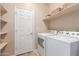 Laundry room with washer, dryer, and shelving at 3703 W Mccauley Ct, Phoenix, AZ 85086