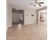 Open living area with tiled floors, neutral color scheme, and kitchen view at 3703 W Mccauley Ct, Phoenix, AZ 85086