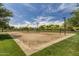 Outdoor sand volleyball court surrounded by green lawns and mature trees, perfect for recreation and community engagement at 3703 W Mccauley Ct, Phoenix, AZ 85086