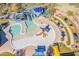 Aerial view of a community water park with pools, slides, and colorful umbrellas for shaded seating areas at 3703 W Mccauley Ct, Phoenix, AZ 85086