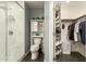 Modern bathroom with marble shower, toilet, and adjacent closet at 4028 W Palo Verde Dr, Phoenix, AZ 85019