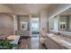 Spa-like bathroom with double vanities, a free-standing tub, and views of the bedroom at 41104 N 96Th St, Scottsdale, AZ 85262