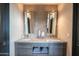 Modern bathroom with double vanity, marble countertop, and large mirror at 41104 N 96Th St, Scottsdale, AZ 85262