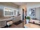 Elegant bathroom boasts a double vanity, a large soaking tub, and a walk-in closet at 41104 N 96Th St, Scottsdale, AZ 85262