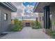 Landscaped courtyard with modern gate and desert plants separating home wings at 41104 N 96Th St, Scottsdale, AZ 85262