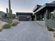 Modern home exterior with a paved driveway and desert landscaping at 41104 N 96Th St, Scottsdale, AZ 85262