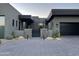 Contemporary home exterior with a gray facade and metal gate at 41104 N 96Th St, Scottsdale, AZ 85262