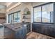 Modern kitchen with expansive windows, island, and high-end appliances at 41104 N 96Th St, Scottsdale, AZ 85262