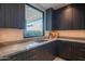 Modern laundry room with ample cabinetry and a window at 41104 N 96Th St, Scottsdale, AZ 85262