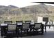 Expansive patio with dining table and chairs, offering scenic mountain views at 41104 N 96Th St, Scottsdale, AZ 85262