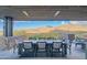 Covered patio with mountain views, dining table, and seating area at 41104 N 96Th St, Scottsdale, AZ 85262