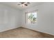 Well-lit bedroom featuring tile flooring and a window with a view at 4212 S 78Th Ln, Phoenix, AZ 85043