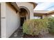 Front entry with arched doorway and well-manicured shrubbery at 4212 S 78Th Ln, Phoenix, AZ 85043