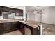 Kitchen with dark wood cabinets and granite countertops at 4212 S 78Th Ln, Phoenix, AZ 85043