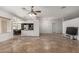 Open living room with tile floors, high ceilings and a ceiling fan at 4212 S 78Th Ln, Phoenix, AZ 85043