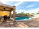 Backyard pool area with covered patio and dining furniture at 4212 S 78Th Ln, Phoenix, AZ 85043