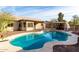 Large kidney shaped pool with a covered patio and diving board at 4212 S 78Th Ln, Phoenix, AZ 85043