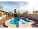 Inviting kidney-shaped pool with diving board and covered patio at 4212 S 78Th Ln, Phoenix, AZ 85043