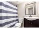 Clean bathroom with a shower/tub combo and vanity at 4240 N 67Th Ln, Phoenix, AZ 85033