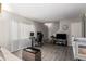 Living room features laminate flooring, a staircase, and a wall-mounted TV at 4240 N 67Th Ln, Phoenix, AZ 85033