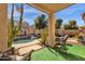 Relaxing backyard with sparkling pool, covered patio, and lush landscaping at 43579 W Arizona Ave, Maricopa, AZ 85138