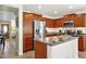 Modern kitchen featuring dark wood cabinets and a large island at 43579 W Arizona Ave, Maricopa, AZ 85138