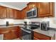 Kitchen with stainless steel appliances and wood cabinets at 43579 W Arizona Ave, Maricopa, AZ 85138