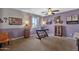 Home office with a desk, wall shelving, and ceiling fan at 43579 W Arizona Ave, Maricopa, AZ 85138