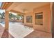 Covered patio with tile flooring, adjacent to a refreshing pool and spacious backyard at 45091 W Cypress Ln, Maricopa, AZ 85139