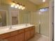 Large bathroom with double sinks and a walk-in shower at 45091 W Cypress Ln, Maricopa, AZ 85139