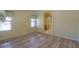 Bright bedroom with wood-look floors and ensuite bathroom access at 45091 W Cypress Ln, Maricopa, AZ 85139