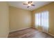 Spacious bedroom with wood-look floors and ceiling fan at 45091 W Cypress Ln, Maricopa, AZ 85139