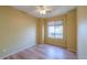 Bedroom with ceiling fan, large window, and laminate flooring at 45091 W Cypress Ln, Maricopa, AZ 85139