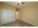 Well-lit bedroom with double door closet and wood-look floors at 45091 W Cypress Ln, Maricopa, AZ 85139