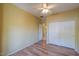 Bedroom with double door closet and laminate flooring at 45091 W Cypress Ln, Maricopa, AZ 85139