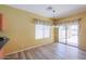 Dining area with wood-look floors and sliding glass doors at 45091 W Cypress Ln, Maricopa, AZ 85139