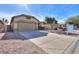 Front view of a house with a two-car garage and a well-maintained yard at 45091 W Cypress Ln, Maricopa, AZ 85139