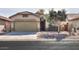 Single-story house with a two-car garage and desert landscaping at 45091 W Cypress Ln, Maricopa, AZ 85139