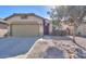 House exterior featuring a two-car garage and drought-tolerant landscaping at 45091 W Cypress Ln, Maricopa, AZ 85139