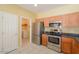 View of kitchen with stainless steel appliances and laundry area at 45091 W Cypress Ln, Maricopa, AZ 85139