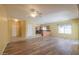 Open living area with wood-like flooring and kitchen access at 45091 W Cypress Ln, Maricopa, AZ 85139