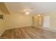 Spacious living room with light walls and wood-look floors at 45091 W Cypress Ln, Maricopa, AZ 85139